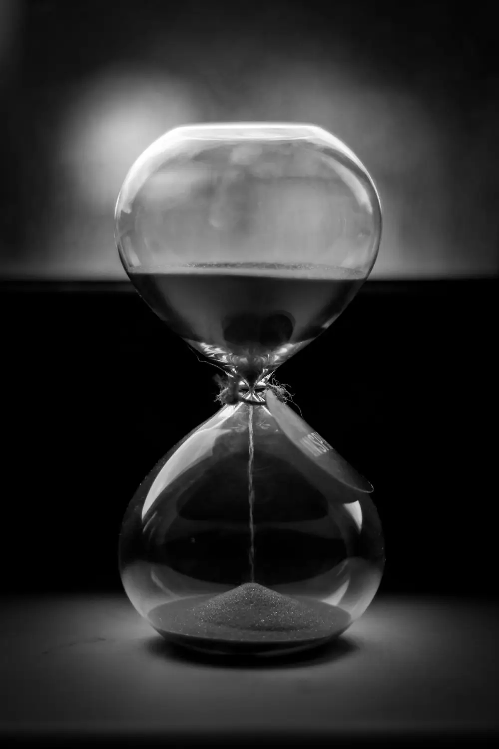 An hourglass running in the dark